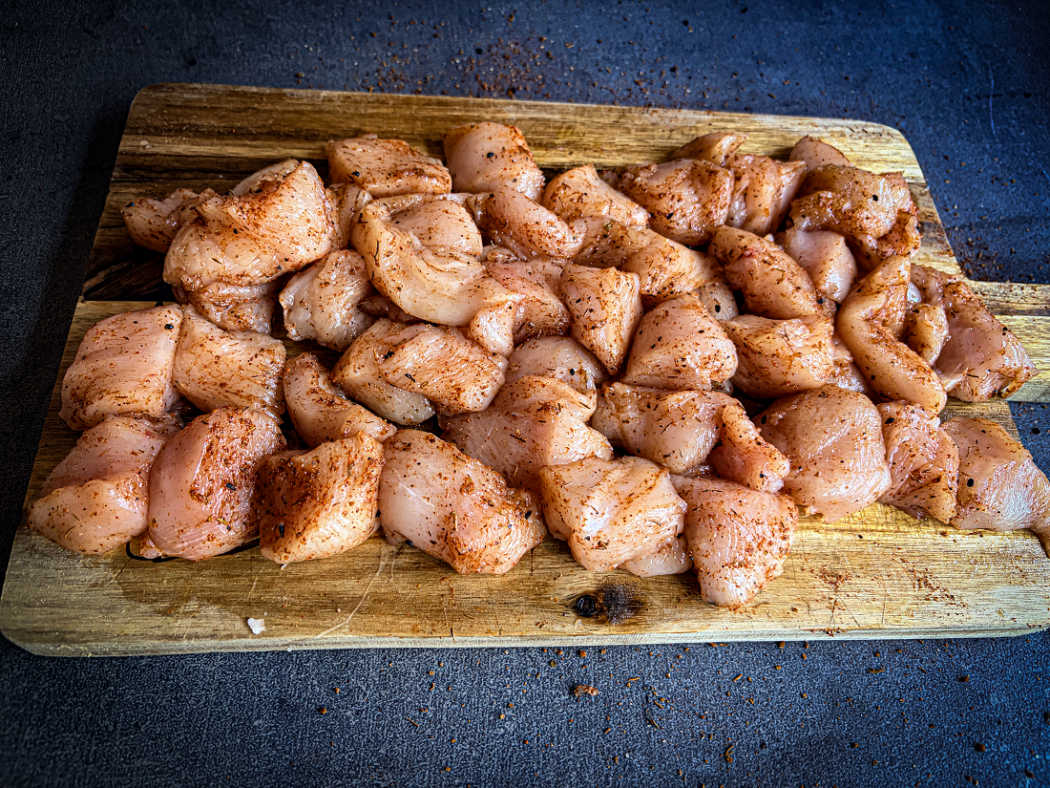 Kipfiletblokjes gekruid met BBQ-rub voor Bang Bang kipspiesen van de BBQ